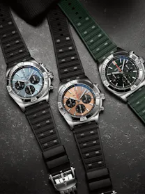 Breitling Chronomat B01 42 watches with different dial colors (light blue, bronze, and green) and matching rubber straps, for sale at The 1916 Company.